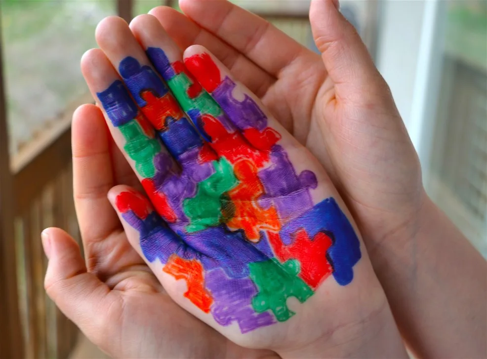 mother-holding-hand-of-child-with-autism