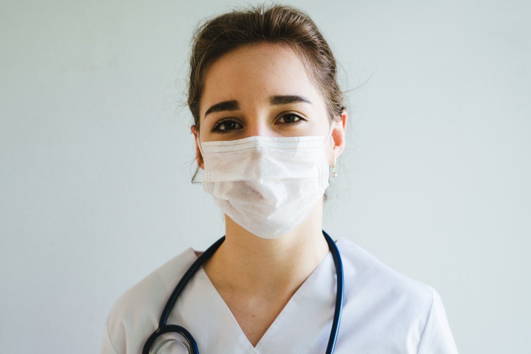 the-girl-is-a-nurse-in-a-protective-mask-on-her