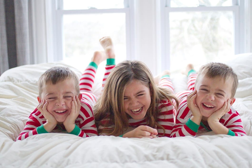 kids-on-bed-in-pajamas-laughing