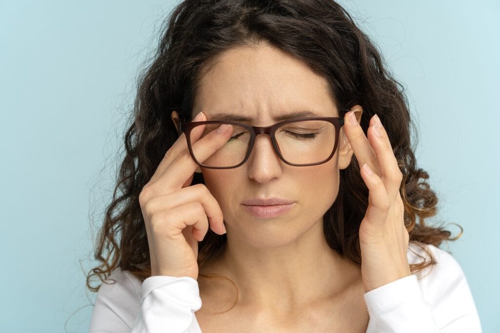 sleepy-business-woman-in-glasses-rubbing-eyes-suff