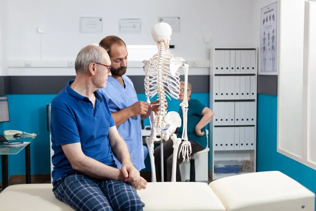 orthopedist-explaining-spinal-cord-on-human-skelet