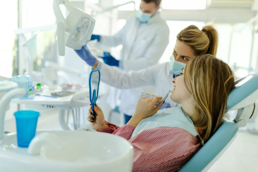 young-woman-sitting-in-dental-chair-and-selecting
