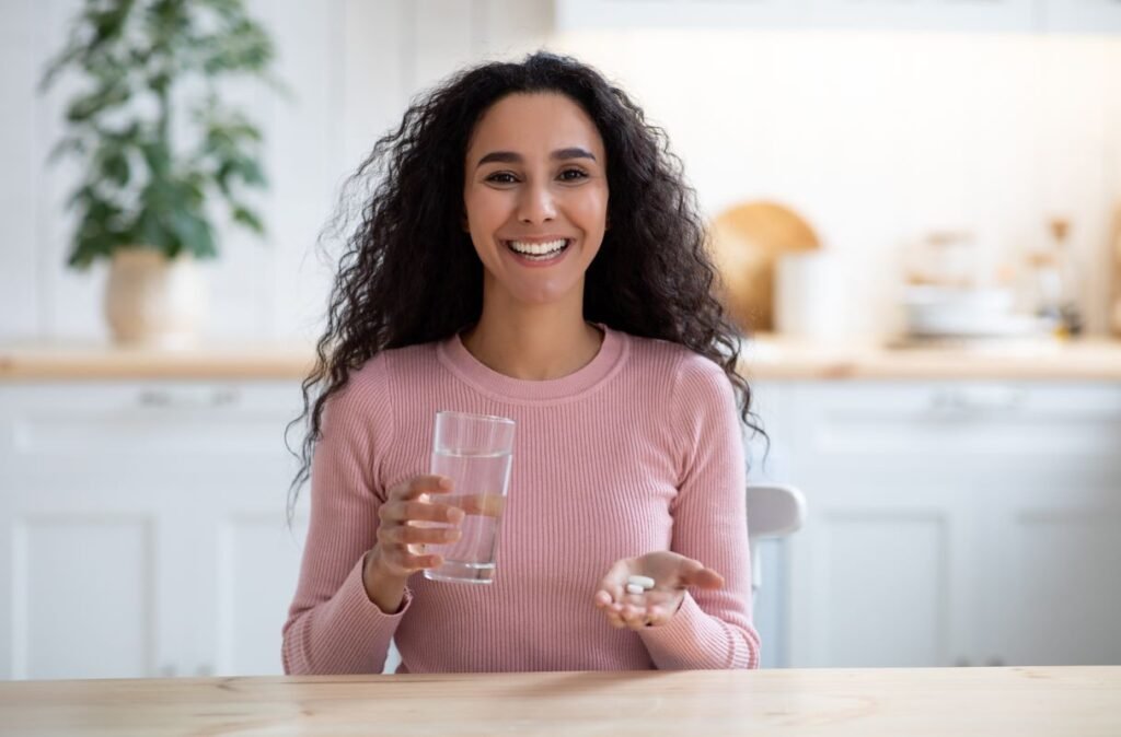 happy-young-brunette-lady-holding-glass-of-water
