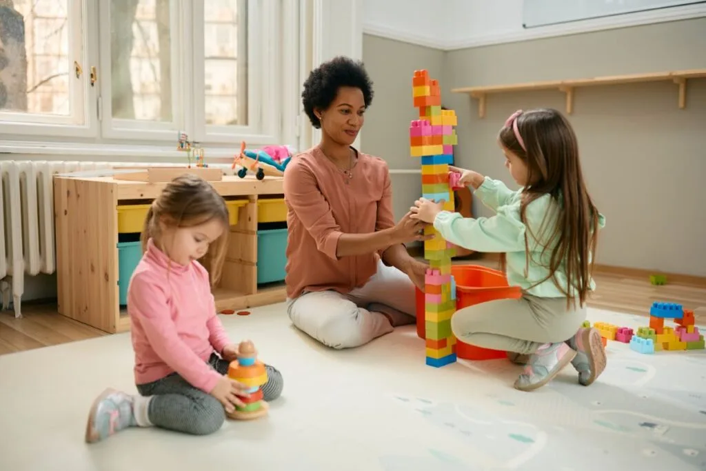 happy-teacher-and-preschool-kids-playing