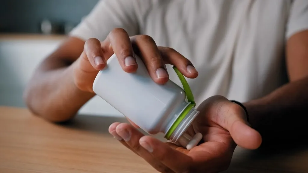 close-up-male-hands-holding-pills