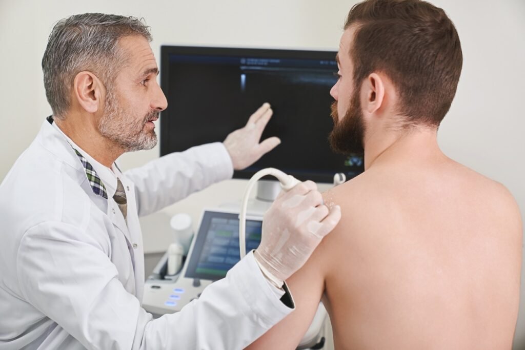 Doctor explaining to patient scan of his shoulder